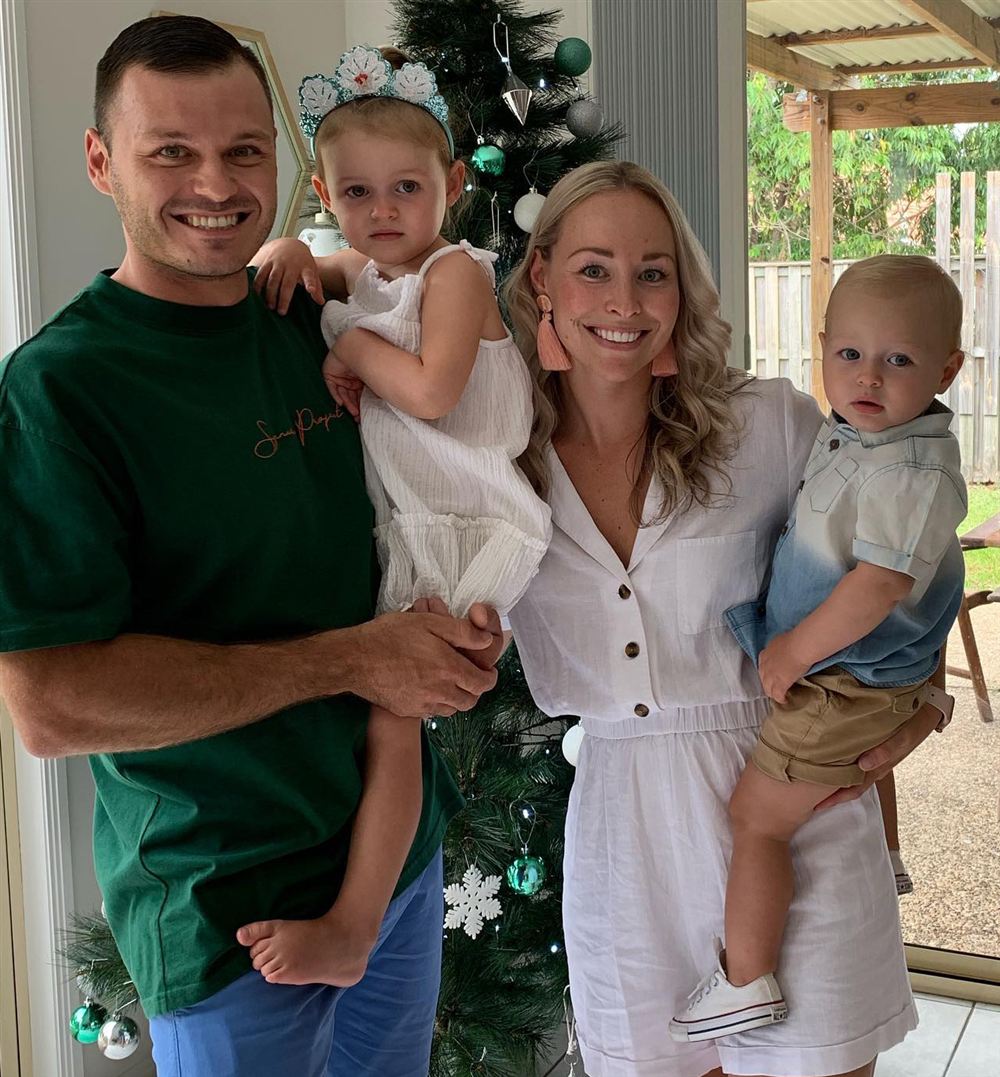 Jesse with his wife and two young children at home